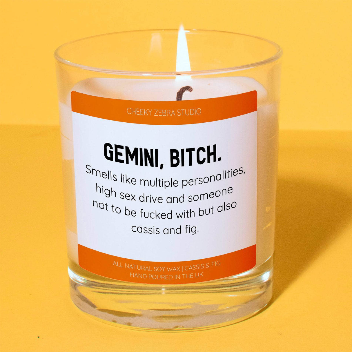 a candle with a label on it sitting on a table