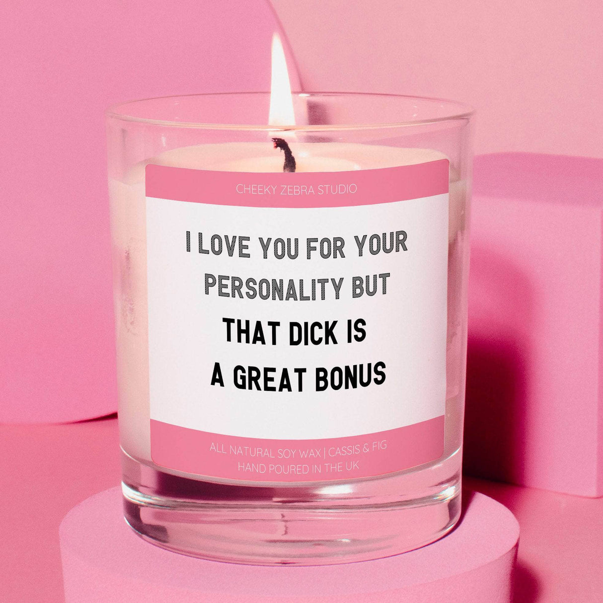 a pink candle with a quote on it