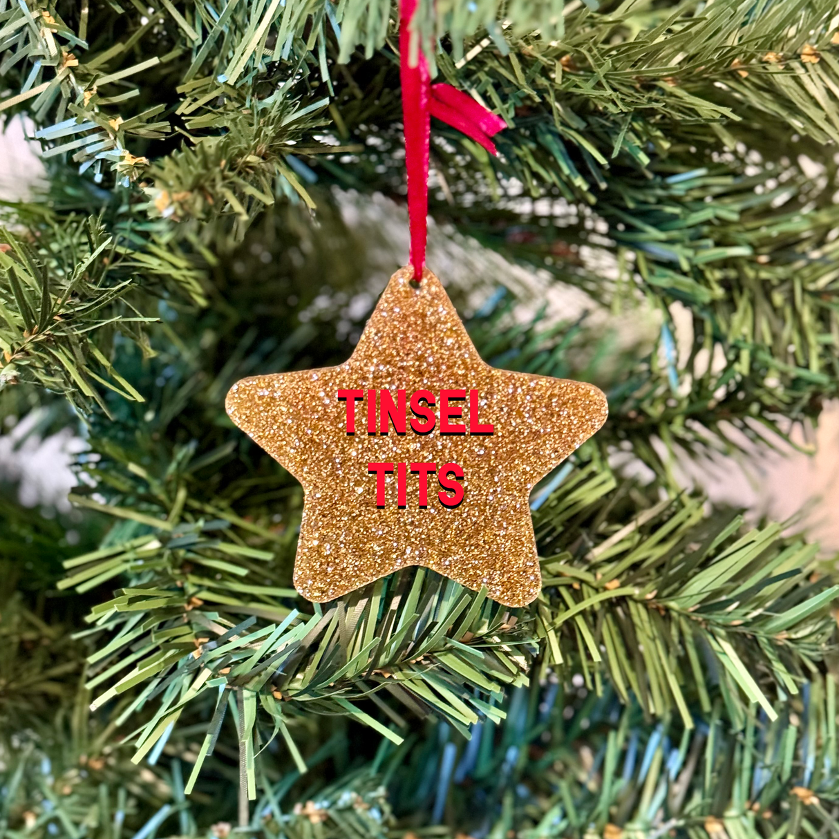 a christmas ornament hanging from a christmas tree