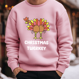 a man wearing a pink christmas sweater with a turkey on it