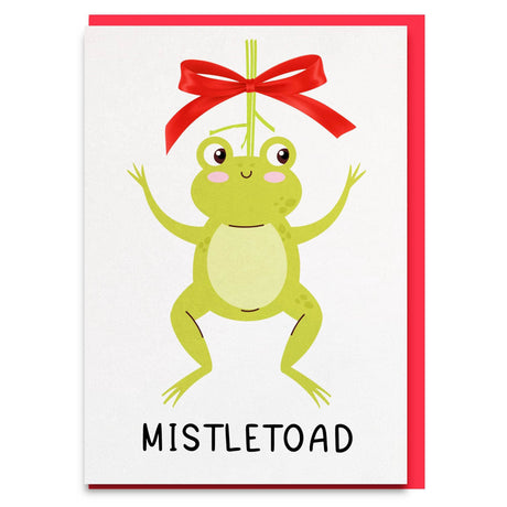 a card with a frog hanging from a red ribbon