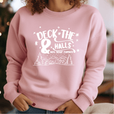 a woman wearing a pink sweatshirt with the slogan deck the 8 hills