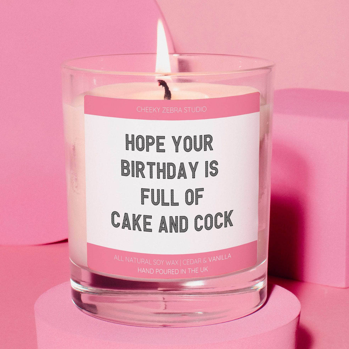 a pink candle with a quote on it