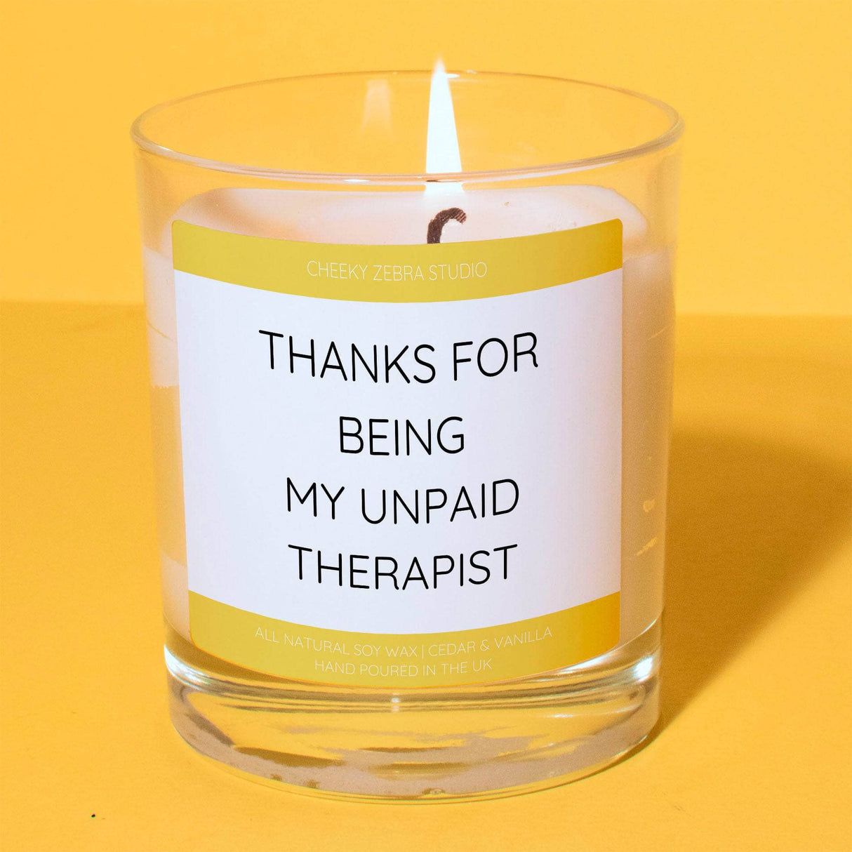 a candle with a label on it that says thanks for being my unpaid