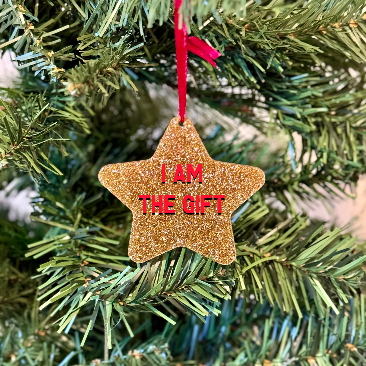 a star ornament hanging from a christmas tree