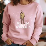 a woman wearing a pink sweater that says it's the holiday armadillo