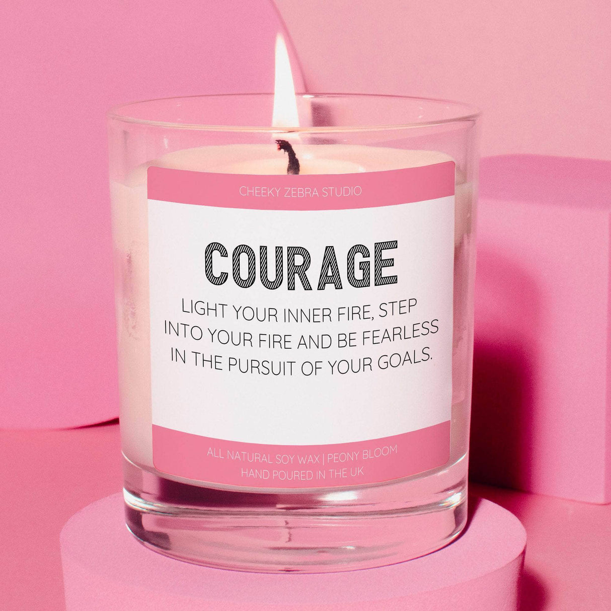 a pink candle with a quote on it